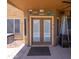 Back patio with a double door and some backyard decor and a propane heater at 12933 W Monterey Way, Avondale, AZ 85392