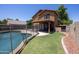 Spacious backyard with a sparkling pool, covered patio, and well-maintained lawn, ideal for entertaining at 12933 W Monterey Way, Avondale, AZ 85392