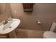 Cozy half-bath with a pedestal sink, neutral walls, and tile flooring at 12933 W Monterey Way, Avondale, AZ 85392