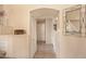 Bright hallway with neutral walls, tile floors, and decorative accents with a mirror at 12933 W Monterey Way, Avondale, AZ 85392