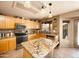 Kitchen with a granite island and countertops, stainless steel appliances, and wooden cabinetry at 12933 W Monterey Way, Avondale, AZ 85392