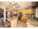 Well-lit kitchen with stainless steel appliances, granite countertops, and light wood cabinetry at 12933 W Monterey Way, Avondale, AZ 85392