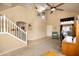 Bright, open living space with vaulted ceilings, neutral carpet and walls, and staircase at 12933 W Monterey Way, Avondale, AZ 85392