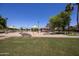 Community playground featuring diverse play structures, seating, and shaded areas for Gathering enjoyment at 12933 W Monterey Way, Avondale, AZ 85392