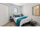 Comfortable bedroom with a window and simple decor, including a soft teal throw blanket at 13227 N Mimosa Dr # 101, Fountain Hills, AZ 85268