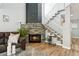 Cozy living room with a stone fireplace, staircase, and hardwood floors at 13227 N Mimosa Dr # 101, Fountain Hills, AZ 85268