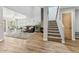 Spacious living room featuring hardwood floors, fireplace, and stairs to the upper level at 13227 N Mimosa Dr # 101, Fountain Hills, AZ 85268