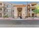 Inviting condo entrance showcasing a grand archway, desert landscaping, and a well-maintained exterior in a vibrant community at 14000 N 94Th N St # 1129, Scottsdale, AZ 85260