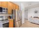Modern kitchen equipped with stainless steel appliances, granite countertops, and wood cabinetry at 14000 N 94Th N St # 1129, Scottsdale, AZ 85260