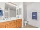 Bathroom features double sinks, wood cabinets, a large mirror, and a separate toilet area at 14000 N 94Th N St # 1129, Scottsdale, AZ 85260