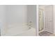 Bathroom with a soaking tub, glass-enclosed shower, and a white door at 14000 N 94Th N St # 1129, Scottsdale, AZ 85260