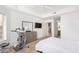 Bright bedroom with a ceiling fan and exercise bike, leading to ensuite bathroom and kitchen at 14000 N 94Th N St # 1129, Scottsdale, AZ 85260
