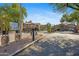 Gated community entrance featuring desert landscaping and well-maintained buildings under a clear blue sky at 14000 N 94Th St # 3198, Scottsdale, AZ 85260