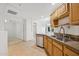 Functional kitchen layout with stainless steel appliances, wooden cabinets, and granite countertops at 14000 N 94Th St # 3198, Scottsdale, AZ 85260