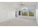 Airy living room featuring neutral carpeting, a ceiling fan, and large windows with scenic views at 14000 N 94Th St # 3198, Scottsdale, AZ 85260