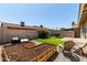 This backyard includes multiple seating options, a dining area and a garden at 14235 N 26Th Ln, Phoenix, AZ 85023