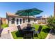 A nice, quaint outdoor eating area with an umbrella is available in this backyard at 14235 N 26Th Ln, Phoenix, AZ 85023