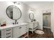 Updated bathroom with dual vanities, dark wood floors, and modern fixtures at 14235 N 26Th Ln, Phoenix, AZ 85023