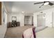 Bright bedroom featuring neutral carpet, ceiling fan, and spacious closet at 14235 N 26Th Ln, Phoenix, AZ 85023