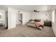 Bright bedroom featuring neutral carpet, ceiling fan, and access to a walk in closet at 14235 N 26Th Ln, Phoenix, AZ 85023