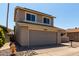 View of the front of the two-story home with a two car garage, grass and rock landscaping at 14235 N 26Th Ln, Phoenix, AZ 85023