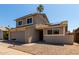 An exterior view of the home featuring a two-car garage, a driveway, and desert landscaping at 14235 N 26Th Ln, Phoenix, AZ 85023