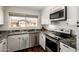 Modern kitchen with stainless steel appliances, granite countertops, and ample cabinet space at 14235 N 26Th Ln, Phoenix, AZ 85023