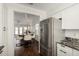 Open layout showcasing the stainless steel refrigerator and view into the adjacent dining and living spaces at 14235 N 26Th Ln, Phoenix, AZ 85023