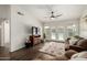 Spacious living room featuring a ceiling fan, wood floors, and sliding glass doors to the patio at 14235 N 26Th Ln, Phoenix, AZ 85023