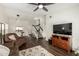 Open-concept living area with wood floors, a staircase, and a view into the dining area and kitchen at 14235 N 26Th Ln, Phoenix, AZ 85023