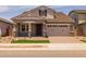 Charming home with well-manicured lawn, beautiful brick driveway, and a two-car garage at 15634 W Georgia Dr, Surprise, AZ 85379