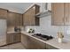 Modern kitchen with stainless steel appliances, quartz countertops, and stylish backsplash at 15634 W Georgia Dr, Surprise, AZ 85379