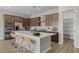 Kitchen featuring a large island with barstool seating, ample cabinetry and stainless steel appliances at 15634 W Georgia Dr, Surprise, AZ 85379