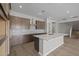 Open kitchen with island, stainless appliances, and a view to the stairway at 15634 W Georgia Dr, Surprise, AZ 85379
