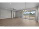 Spacious living area with hardwood floors, ceiling fan, and sliding glass door to backyard at 15634 W Georgia Dr, Surprise, AZ 85379
