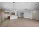 Open-concept living area with hardwood floors, modern kitchen, and stairway at 15634 W Georgia Dr, Surprise, AZ 85379