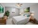 Cozy main bedroom with side tables, plants, and a large window view at 15634 W Georgia Dr, Surprise, AZ 85379