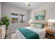 Stylishly staged bedroom with modern decor, neutral carpet, ceiling fan, and natural light at 15634 W Georgia Dr, Surprise, AZ 85379