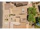An aerial view displays a property featuring desert landscaping, a well-maintained roof, and mature trees at 1606 N Apache Dr, Chandler, AZ 85244