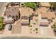 Aerial view of a well-maintained residential property with a three-car garage and charming desert landscaping at 1606 N Apache Dr, Chandler, AZ 85244