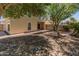 An attractive backyard features low-maintenance landscaping and a covered patio area with mature trees providing shade at 1606 N Apache Dr, Chandler, AZ 85244