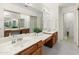 Bright bathroom featuring dual sinks, marble counters and tile flooring at 1606 N Apache Dr, Chandler, AZ 85244