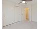Well-lit bedroom featuring neutral carpeting, sliding door closet, and a ceiling fan at 1606 N Apache Dr, Chandler, AZ 85244