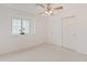 Bedroom with neutral carpet, ceiling fan, closet and a window at 1606 N Apache Dr, Chandler, AZ 85244