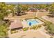 A community pool is surrounded by lush greenery and seating areas, offering a relaxing outdoor space at 1606 N Apache Dr, Chandler, AZ 85244