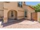 Inviting home entrance with desert landscaping, an arched doorway, and decorative stonework, offering great curb appeal at 1606 N Apache Dr, Chandler, AZ 85244