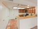 Galley kitchen boasts wooden cabinets, peninsula, and tile flooring at 1606 N Apache Dr, Chandler, AZ 85244