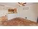 Cozy kitchen with wood cabinets, breakfast bar, and warm tile flooring at 1606 N Apache Dr, Chandler, AZ 85244