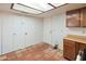 Kitchen with multiple access doors, wooden cabinets and tile floor at 1606 N Apache Dr, Chandler, AZ 85244