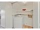 Bright laundry room with white appliances and storage shelves, offering convenience and functionality at 1606 N Apache Dr, Chandler, AZ 85244